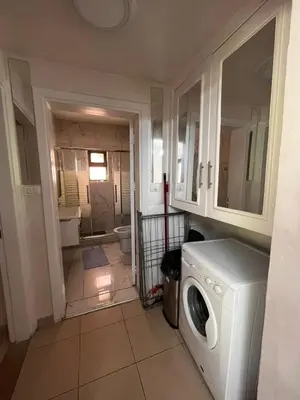 a laundry room with a washer and a bathroom at Nice tow bedrooms by snake pool for families only in Talapay in Aqaba