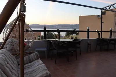 a balcony with a table and chairs and a view at Golden View in Aqaba