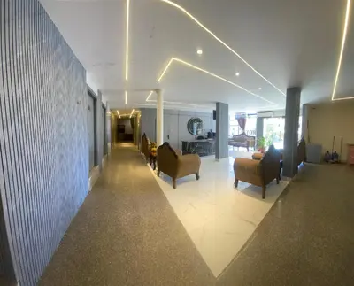 a hallway with chairs and a living room at Golden View in Aqaba