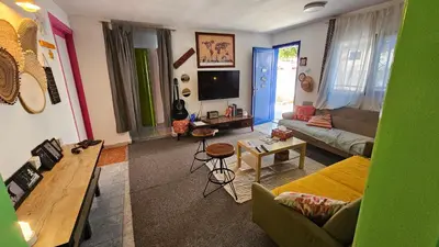 a living room with a couch and a tv at Mango Haus in Aqaba
