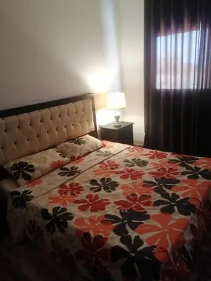 a bedroom with a bed with a flowered comforter at The Stunning View in Wadi Musa