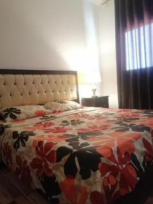 a bedroom with a bed with a floral bedspread at The Stunning View in Wadi Musa