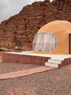 a dome tent in front of a mountain at Wadi rum stay in Wadi Rum