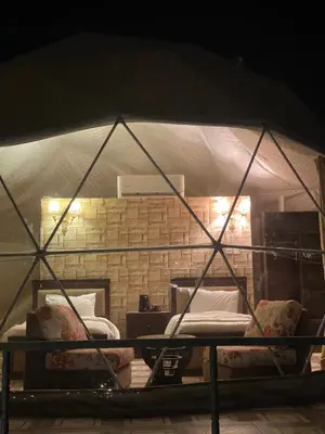 a room with two beds in a tent at WADi RUM LUXURY RITZ in Wadi Rum