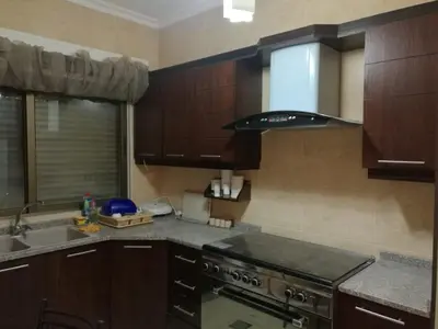 a kitchen with a stove top oven next to a sink at Dream Home in Amman