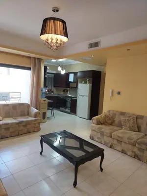 a living room with couches and a coffee table at Dream Home in Amman