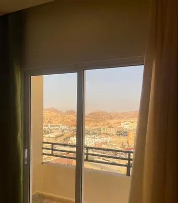 a window with a view of a city at RoadHouse - Petra in Wadi Musa