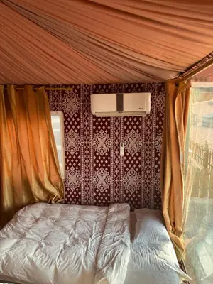 a bed in the back of a tent at Al Raha Luxury Camp in Wadi Rum