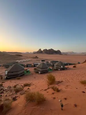 a group of tents in the middle of a desert at Al Raha Luxury Camp in Wadi Rum