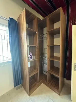 a closet with wooden shelves and a blue curtain at Antica old apartment al-lwebdeh in Amman