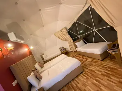 a room with two beds in a tent at RUM ARJAAN lUXURY CAMP in Wadi Rum