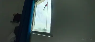 a window in a room with a flag on it at Happy Beach For Studio Rooms Apartment شاطئ السعادة للشقق المفروشة in Aqaba