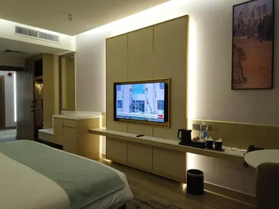 a bedroom with a bed and a television on a wall at H Luxury Hotel in Wadi Musa