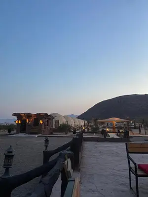 a view of a patio with mountains in the background at Adel Wadi Rum Camp Bubble in Wadi Rum