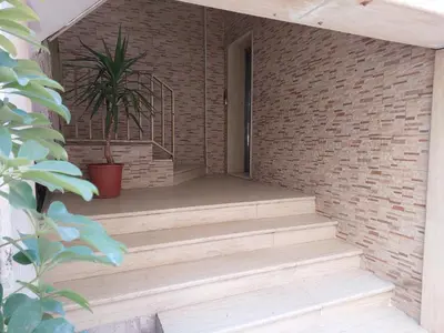 a brick wall with stairs and a potted plant at Cozy Home 2 in Amman