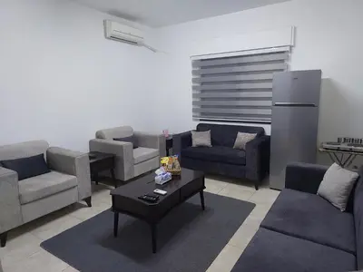 a living room with couches and a coffee table at Cozy Home 3 in Amman