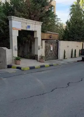 an empty street with a building with a gate at Amman Business Park Apartment in Amman