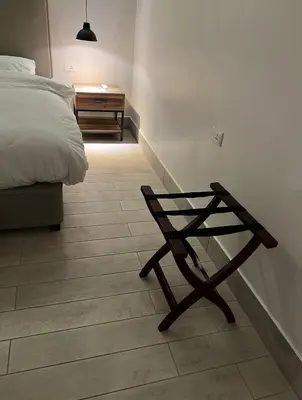 a bedroom with a bed and a wooden table at Zerø Føur DeadSea in Sowayma