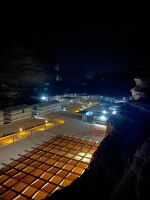 a view of a city at night with lights at wadi rum Golden Sand in Wadi Rum