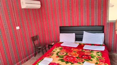 a bedroom with a bed with flowers on it at wadi rum Golden Sand in Wadi Rum