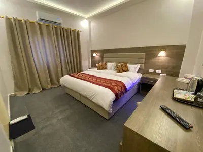 a hotel room with a bed and a desk at Petra Oleander Hotel in Wadi Musa