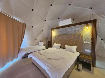 a bedroom with two beds in a tent at غرووب وادي رم in Wadi Rum