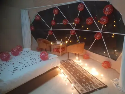 a room with a bed with red balls on it at غرووب وادي رم in Wadi Rum