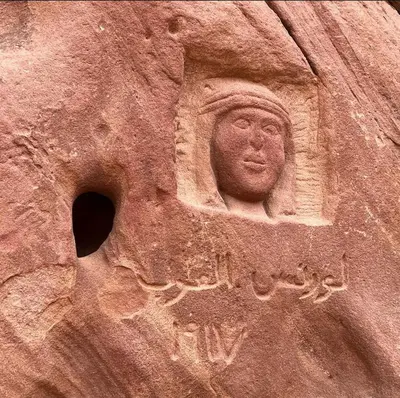 a stone statue of a man on a wall at غرووب وادي رم in Wadi Rum
