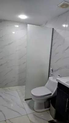 a white bathroom with a toilet and a sink at Wadi rum sky luxury in Wadi Rum
