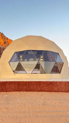 a large dome building with windows in the desert at Wadi rum sky luxury in Wadi Rum