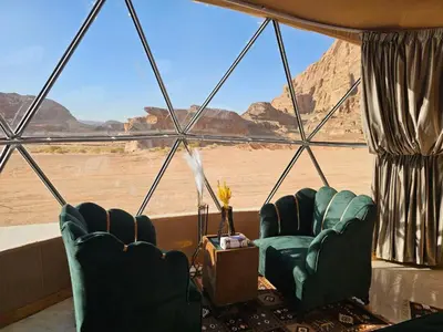 two chairs in a room with a view of the desert at Rand desert camp in Wadi Rum