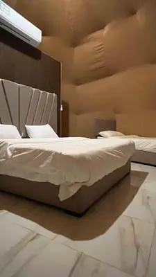 a bedroom with two beds with white sheets at Rum New Luxury Camp in Wadi Rum