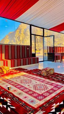 a bedroom with a bed with a view of a mountain at Bedouin oasis in Wadi Rum