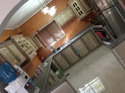an overhead view of a kitchen with green cabinets at بيت العُمري (ام قيس) in Um Qeis