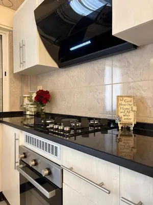 a kitchen with a stove top oven in a kitchen at Exquisite & inviting 2 Bedroom 2 bath Balcony Fast internet in Amman