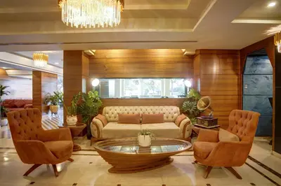 a living room with a couch and chairs and a table at Dweik Hotel LUXURY 3 in Aqaba