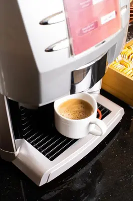 a coffee maker with a cup of coffee at Dweik Hotel LUXURY 3 in Aqaba