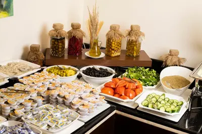 a buffet with different types of food on a table at Dweik Hotel LUXURY 3 in Aqaba