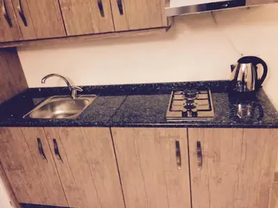 a kitchen counter with a stove and a sink at The Royal Luxury Queen Terrace 1 in Amman