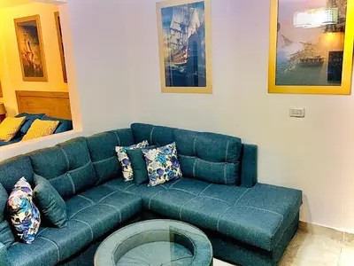 a blue couch sitting in a living room at The Royal Luxury Queen Terrace 1 in Amman