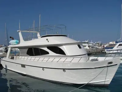 a white boat is docked in the water at The Royal Luxury Lion Patio in Amman