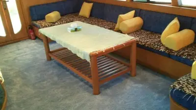 a table and a bench with a table and chairs at The Royal Luxury Tiger Patio in Amman