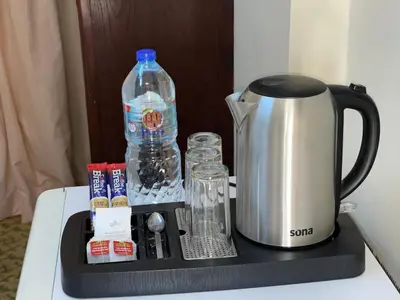 a tray with a coffee maker and a bottle of water at Dweik Rooftop in Aqaba