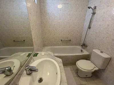 a bathroom with a toilet and a sink and a tub at Dweik Rooftop in Aqaba