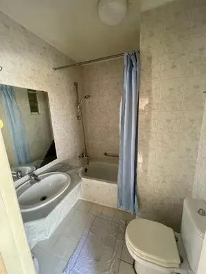 a bathroom with a tub and a sink and a toilet at Dweik Rooftop in Aqaba