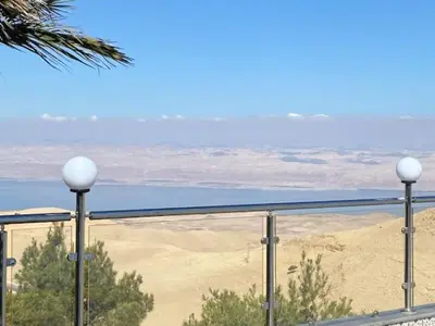 a view of the desert and the ocean from a balcony at Golden rays chalet in Madaba