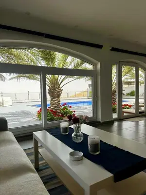 a living room with a couch and a table at Golden rays chalet in Madaba