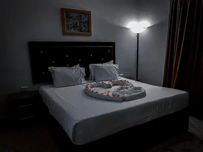 a bed with a cake on top of it at Plaza View Hostel in Taiyiba
