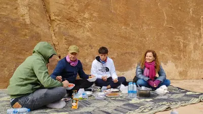 a group of people sitting around a picnic table at Wadi rum safari 1 camp in Wadi Rum