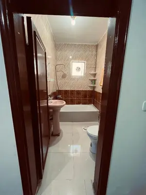 a bathroom with a toilet and a tub and a sink at Petra Gold Inn Apartments in Wadi Musa